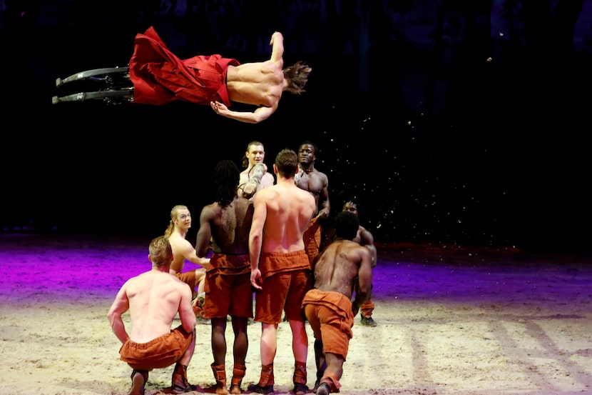 A performer on stilts does a flip over a series of logs during a preview of Cavalia's...