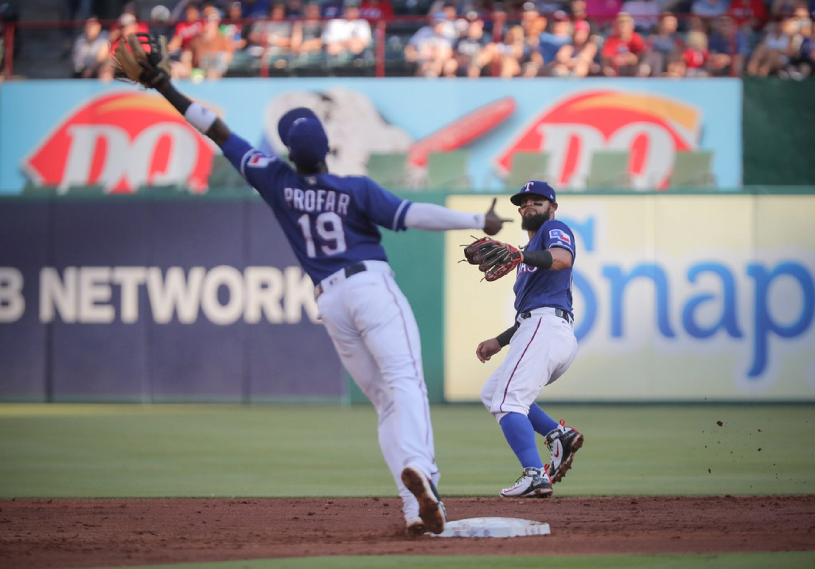 Texas Rangers second baseman Rougned Odor (12) misthrows a ball to shortstop Jurickson...