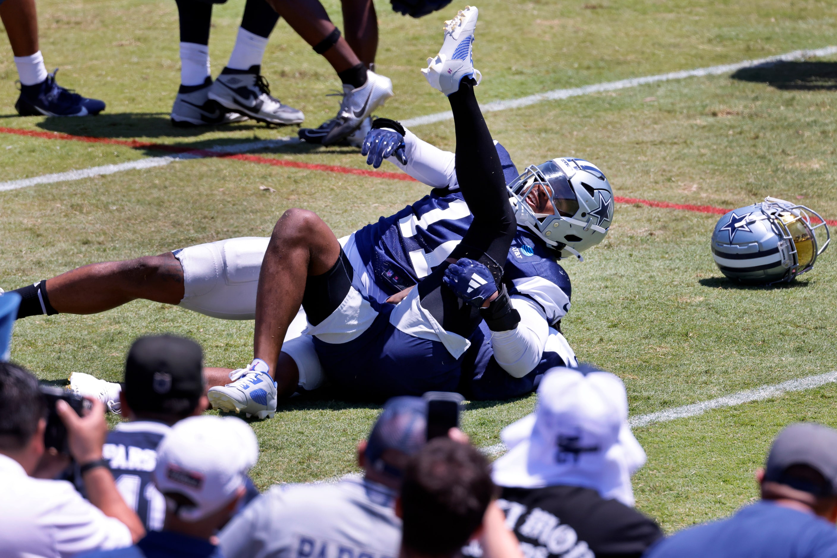 Dallas Cowboys linebacker Micah Parsons (11) pins cornerback Trevon Diggs (7) as the two...