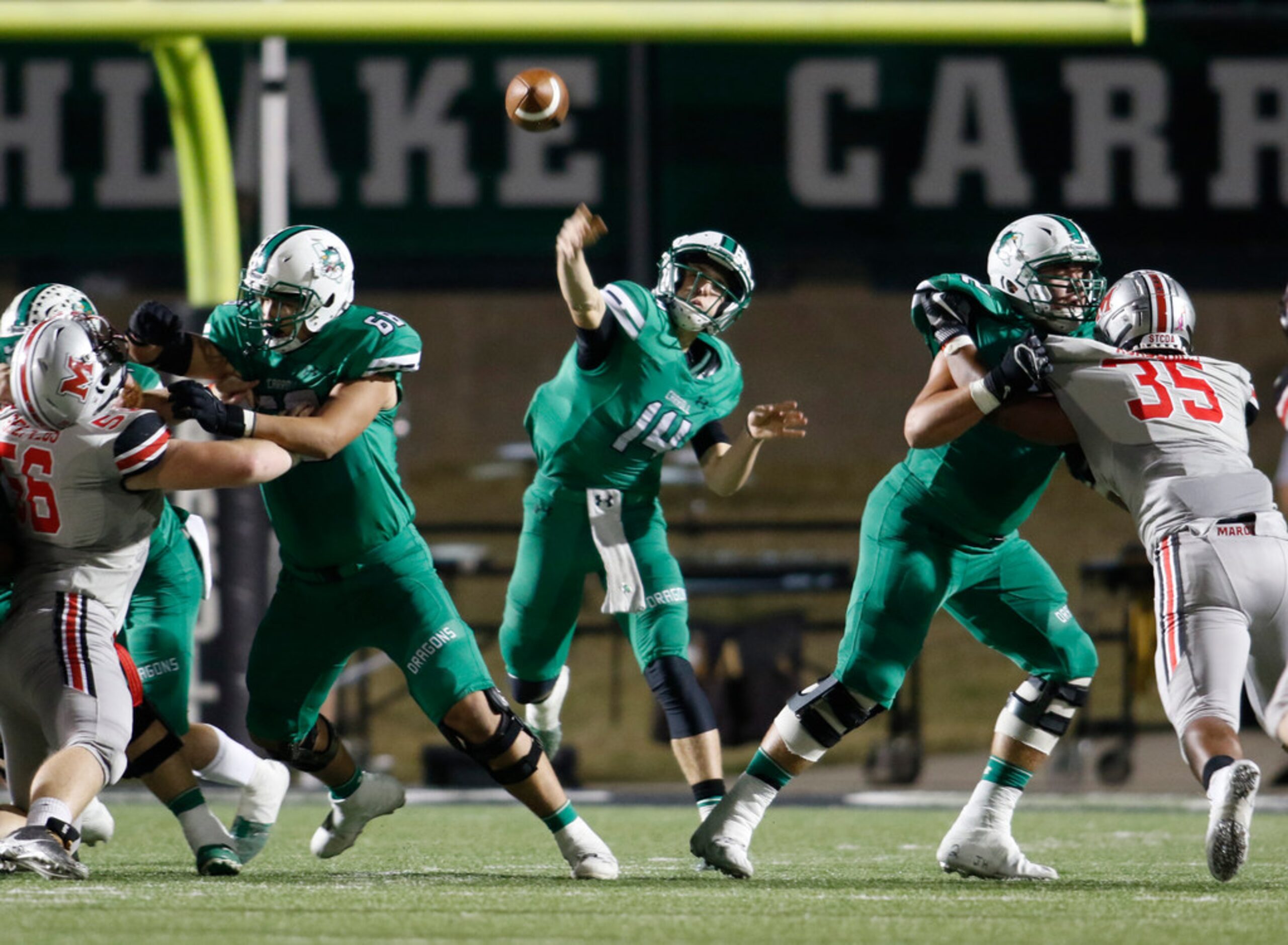 Southlake Carroll quarterback Will Bowers (14) launches a long pass downfield during second...