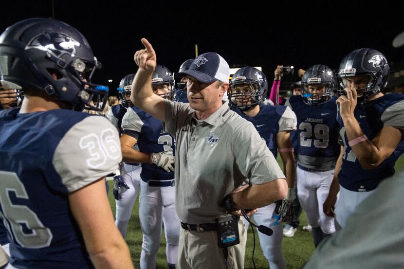 Flower Mound head coach Brian Basil instructs his team before the opening kickoff of a game...