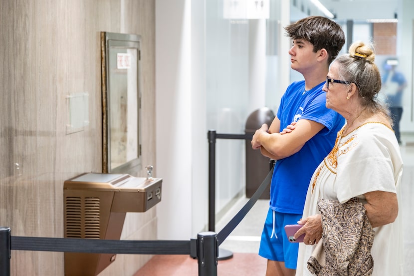 Jill Morgan and her grandson Noah, 13, read a plaque describing how a “Whites Only” drinking...