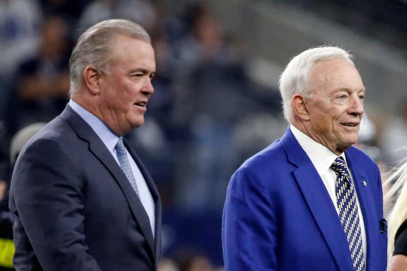 Dallas Cowboys CEO Stephen Jones, left, and team owner Jerry Jones, right, walk across the...
