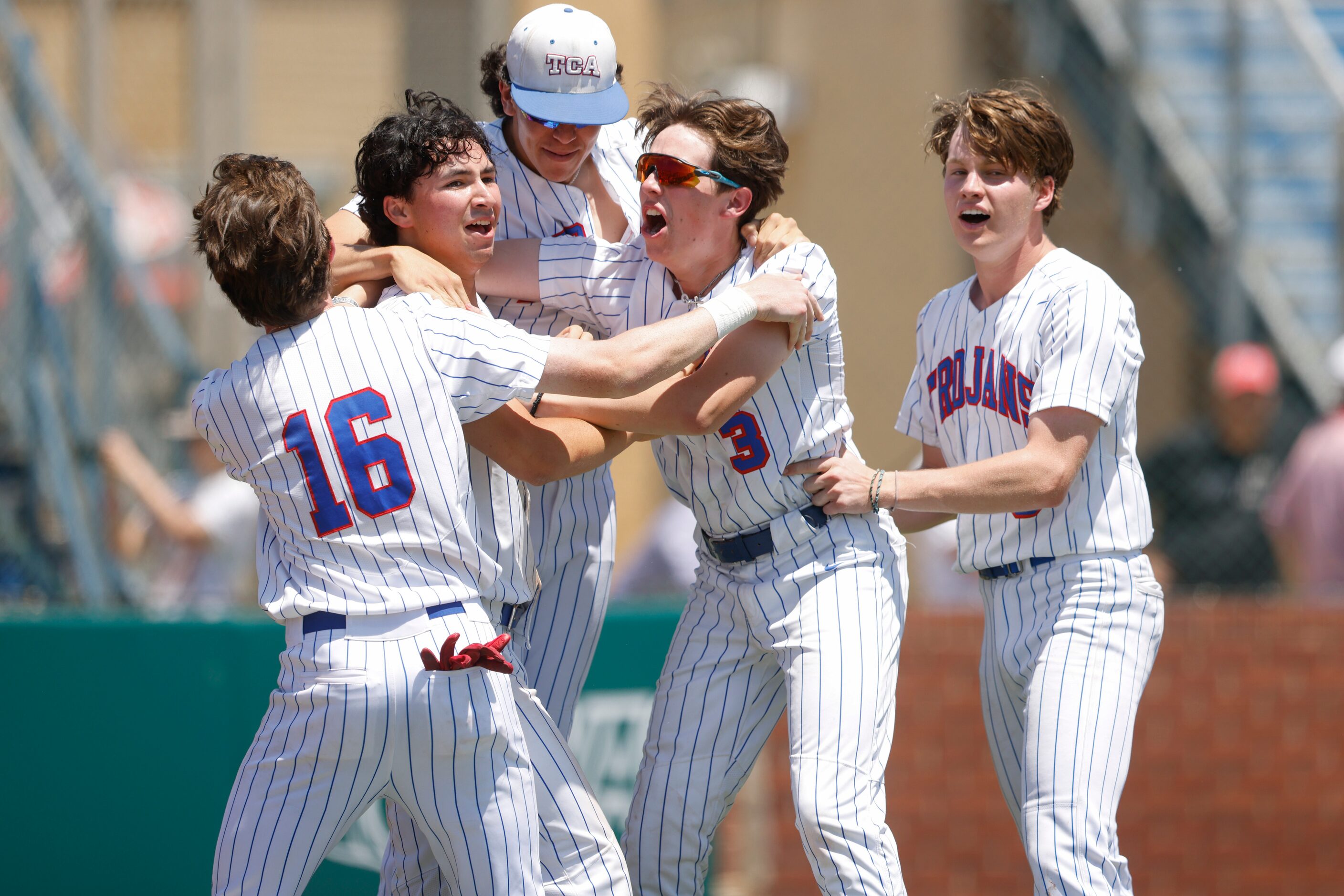 Trinity Christian players run to hug Joshua Liu (9) after his game winning run off of...