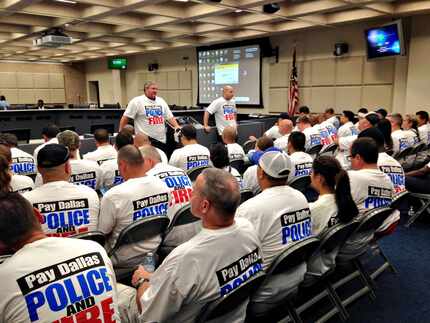 Dallas police officers and firefighters attend a recent City Council budget briefing....
