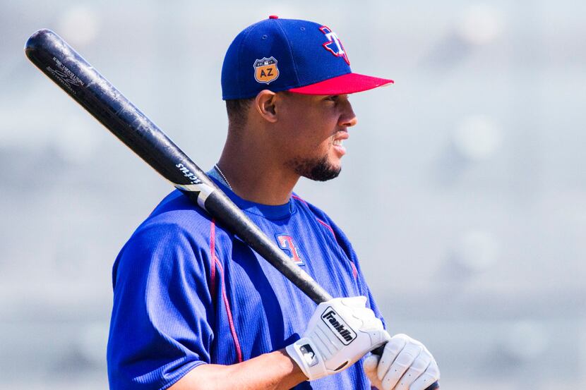 Texas Rangers center fielder Carlos Gomez (14) warm up before batting practice during a...