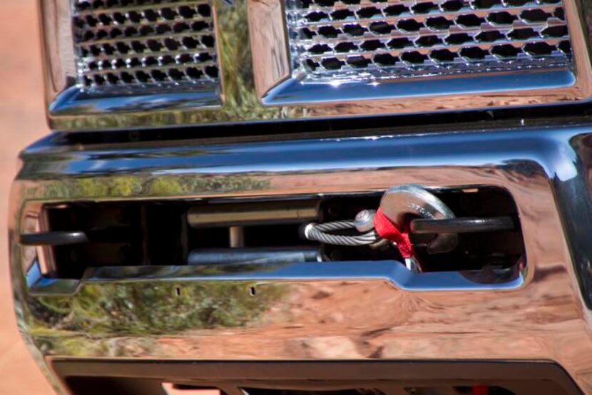 
The hook hanging from the 2014 Ram Power Wagon's bumper is connected to a Warn Winch that...