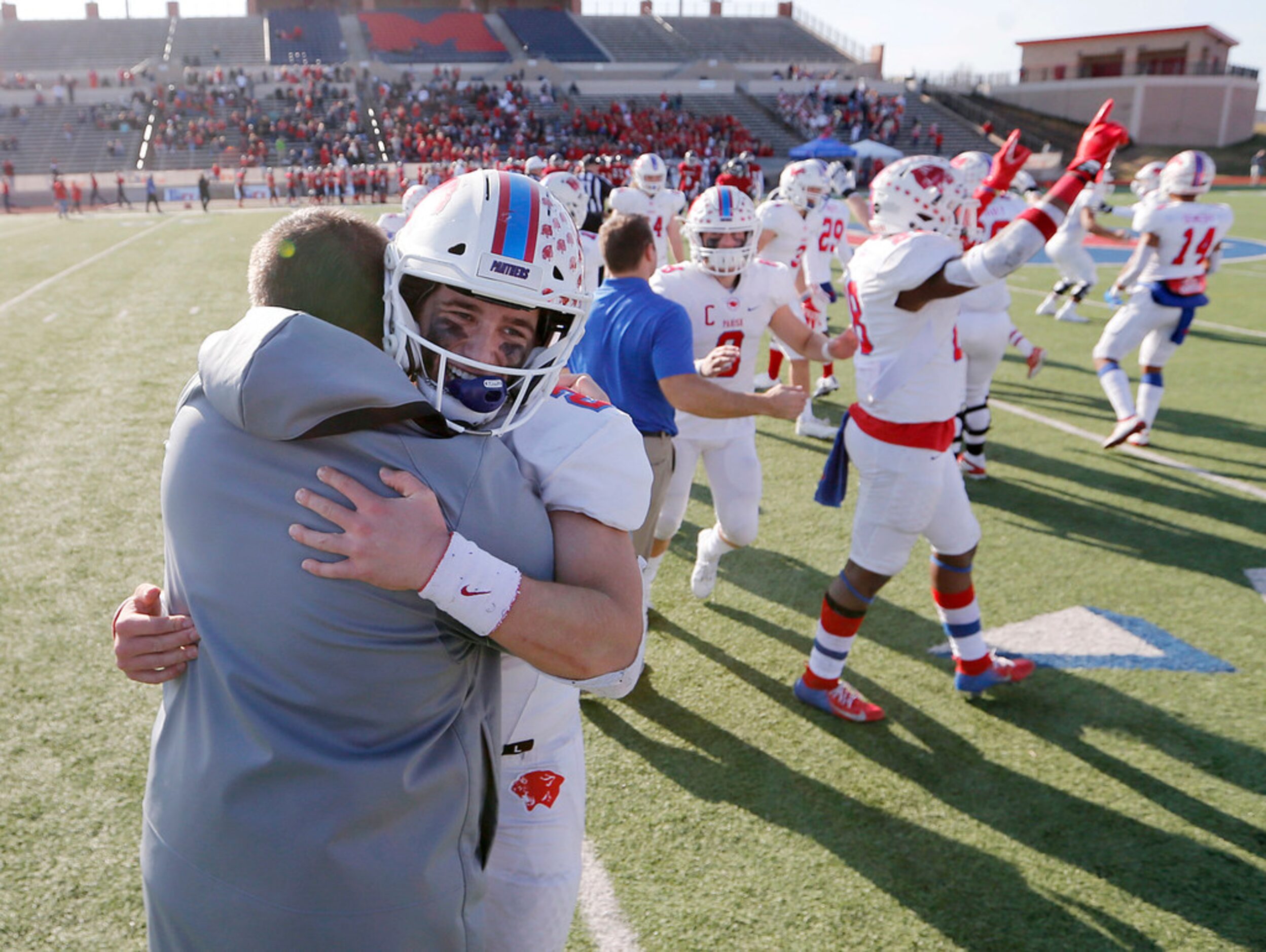 Parish Episcopal's Preston Stone (2) hugs head coach Daniel Novakov in celebration after...