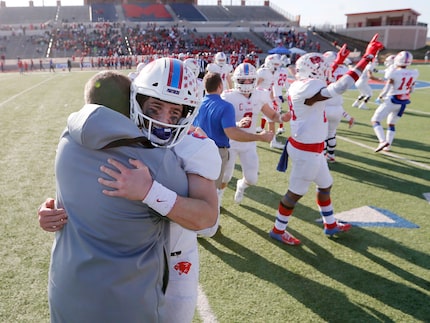 Parish Episcopal's Preston Stone (2) hugs head coach Daniel Novakov in celebration after...