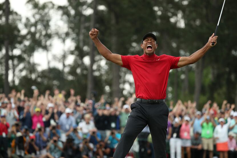 Tiger Woods celebrates after winning the Masters during the final round on Sunday, April 14,...