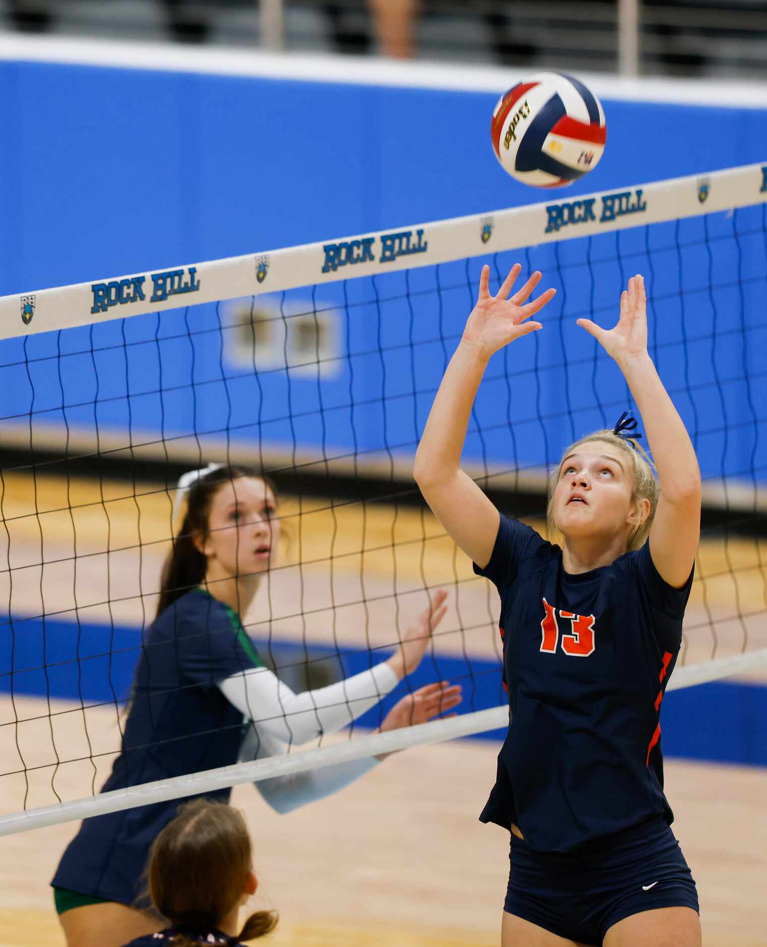 Frisco Wakeland’s Audrey Clark (13) sets the ball against  Frisco Reedy during the first set...