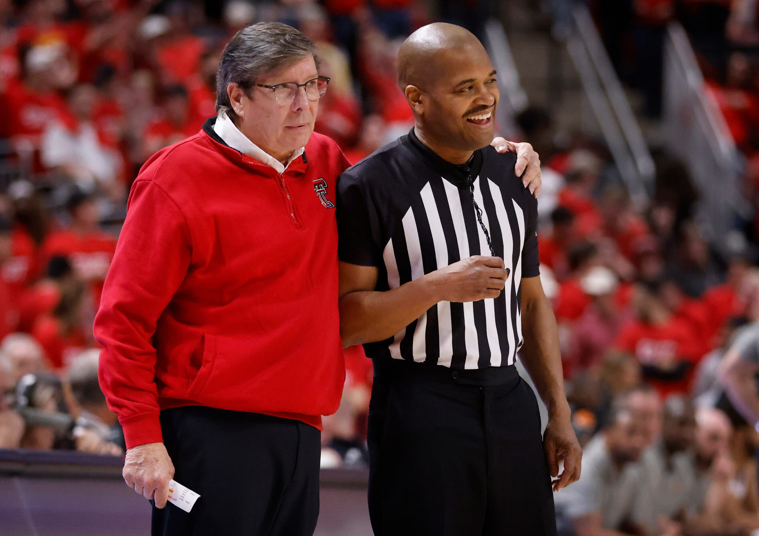 Texas Tech Red Raiders head coach Mark Adams makes the official crack a smile during the...