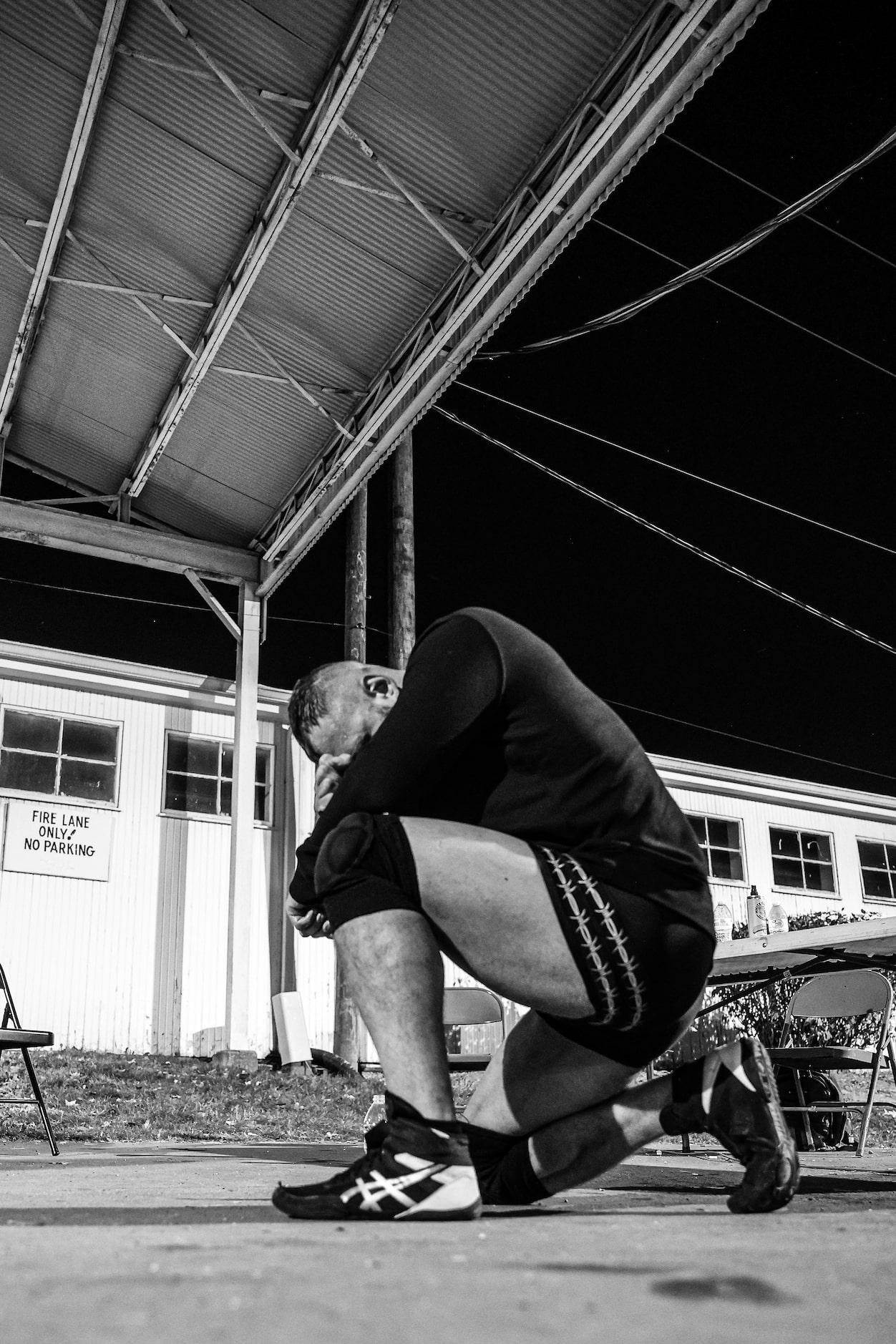 Professional wrestler Jon Moxley kneels before his match at Game Changer Wrestling's...