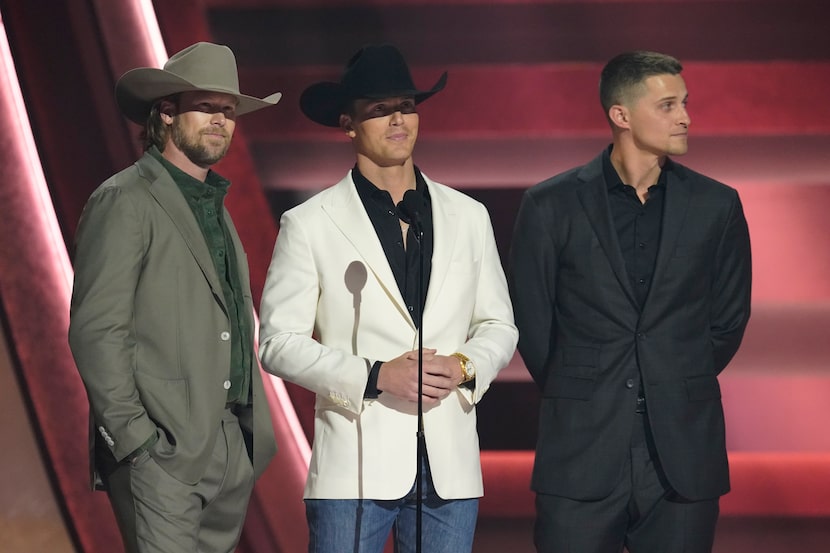 Brian Kelley, from left, Parker McCollum and Corey Seager present the award for single of...