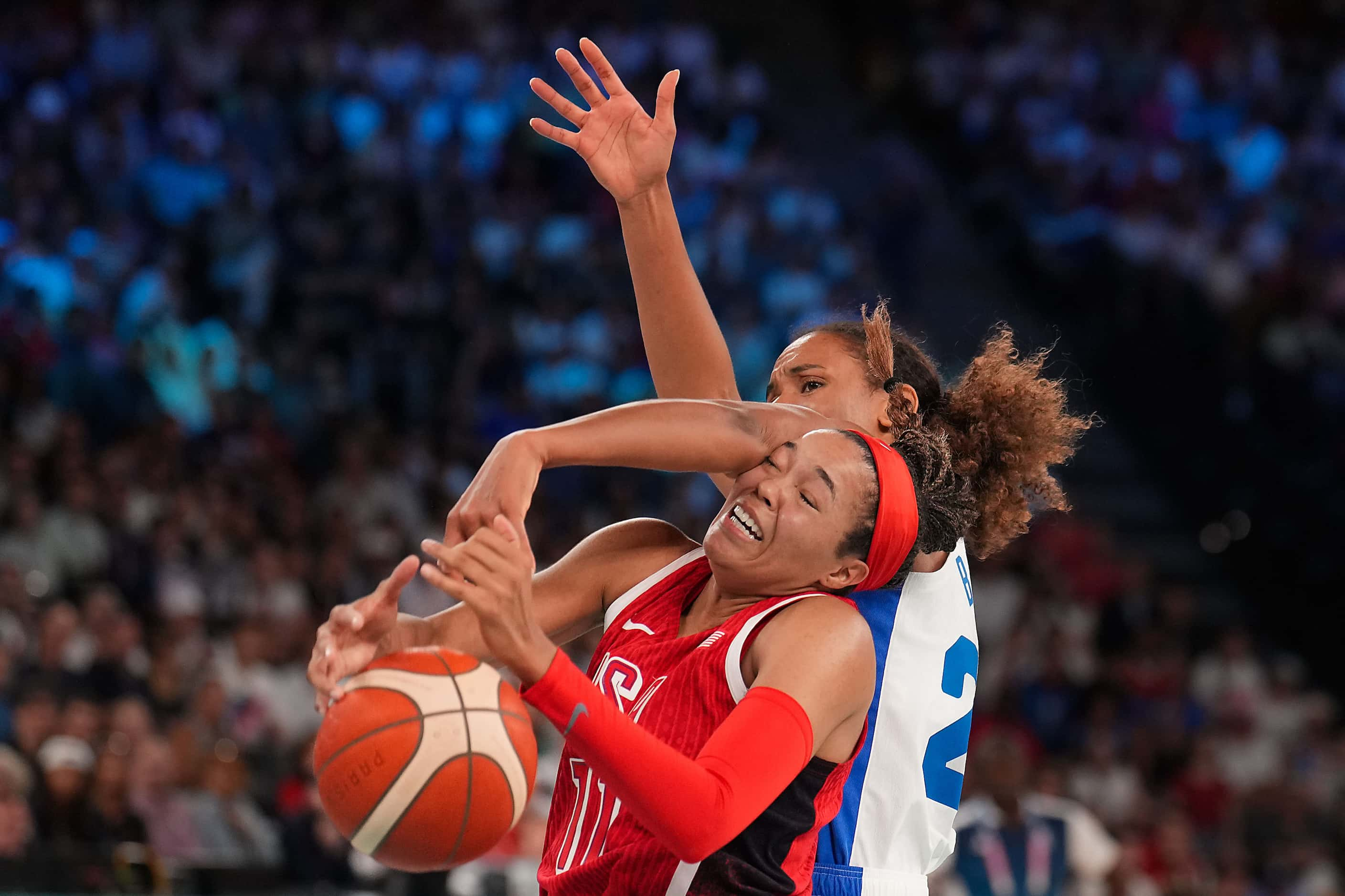 Napheesa Collier (11) of the United States is fouled by Marieme Badiane (22) of France...