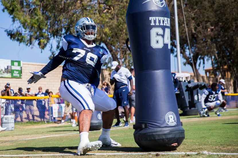 Dallas Cowboys defensive tackle Trysten Hill (79) attacks a dummy during an afternoon...