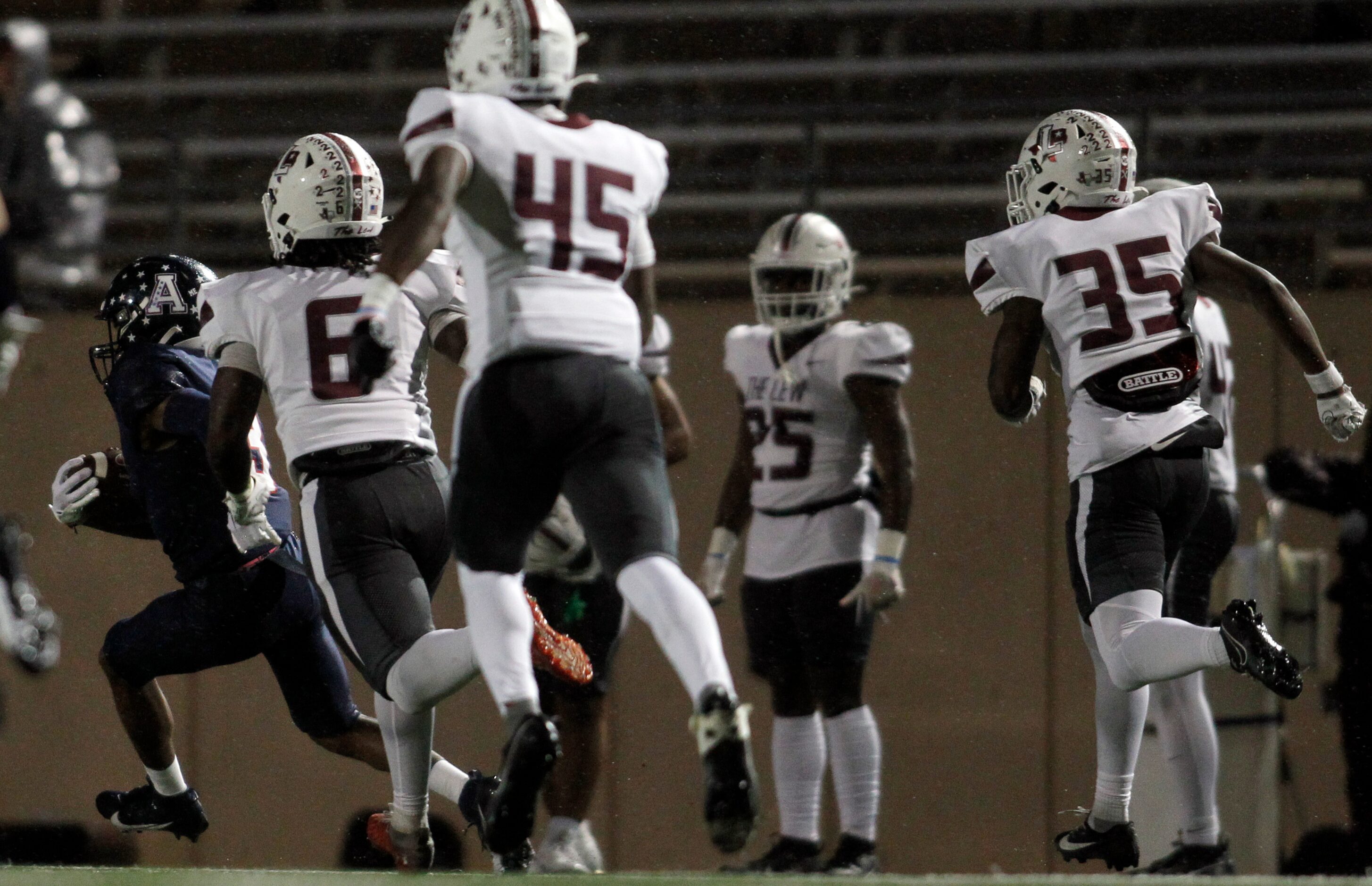 Allen kick returner Caleb Smith (3), left, leaves a trail of Lewisville players behind...