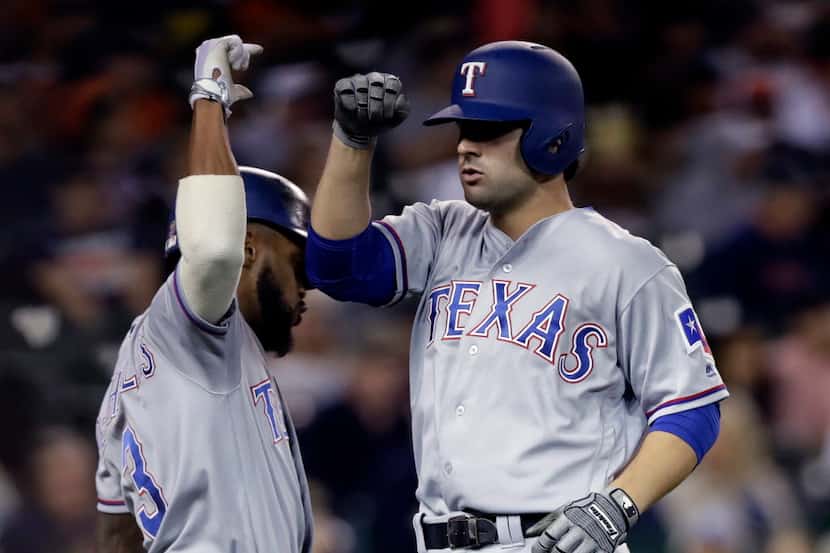 Texas Rangers' Pete Kozma, right, is congratulated by Delino DeShields after hitting a solo...