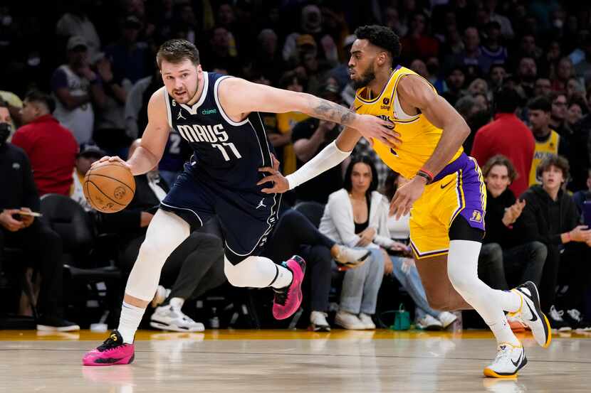 Dallas Mavericks' Luka Doncic (77) drives past Los Angeles Lakers' Troy Brown Jr. (7) in the...