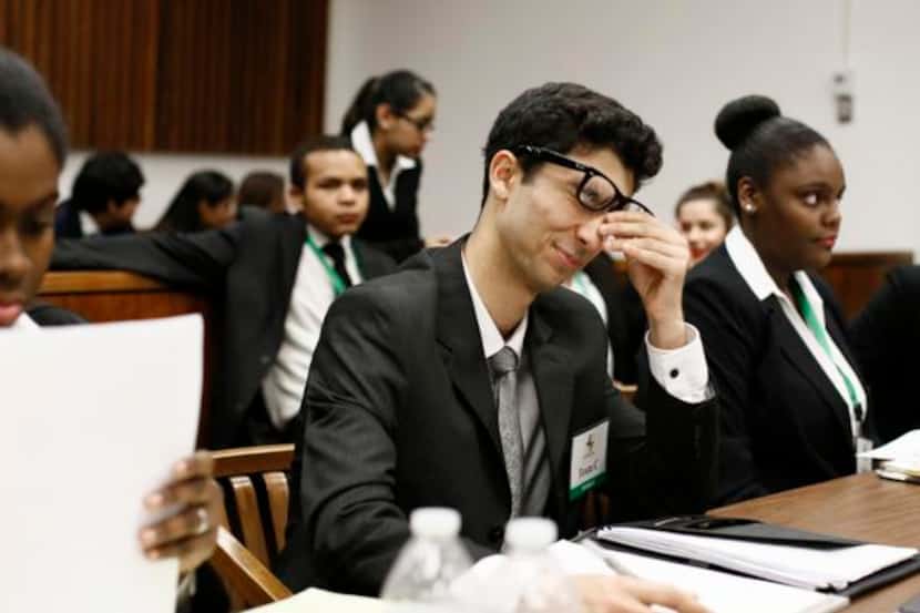 
Creekview High School’s Ali Aldabaja rubs his eyes before the third round of trials at the...