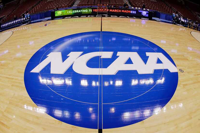 FILE - In this March 21, 2013, file photo taken with a fisheye lens, the NCAA logo is...