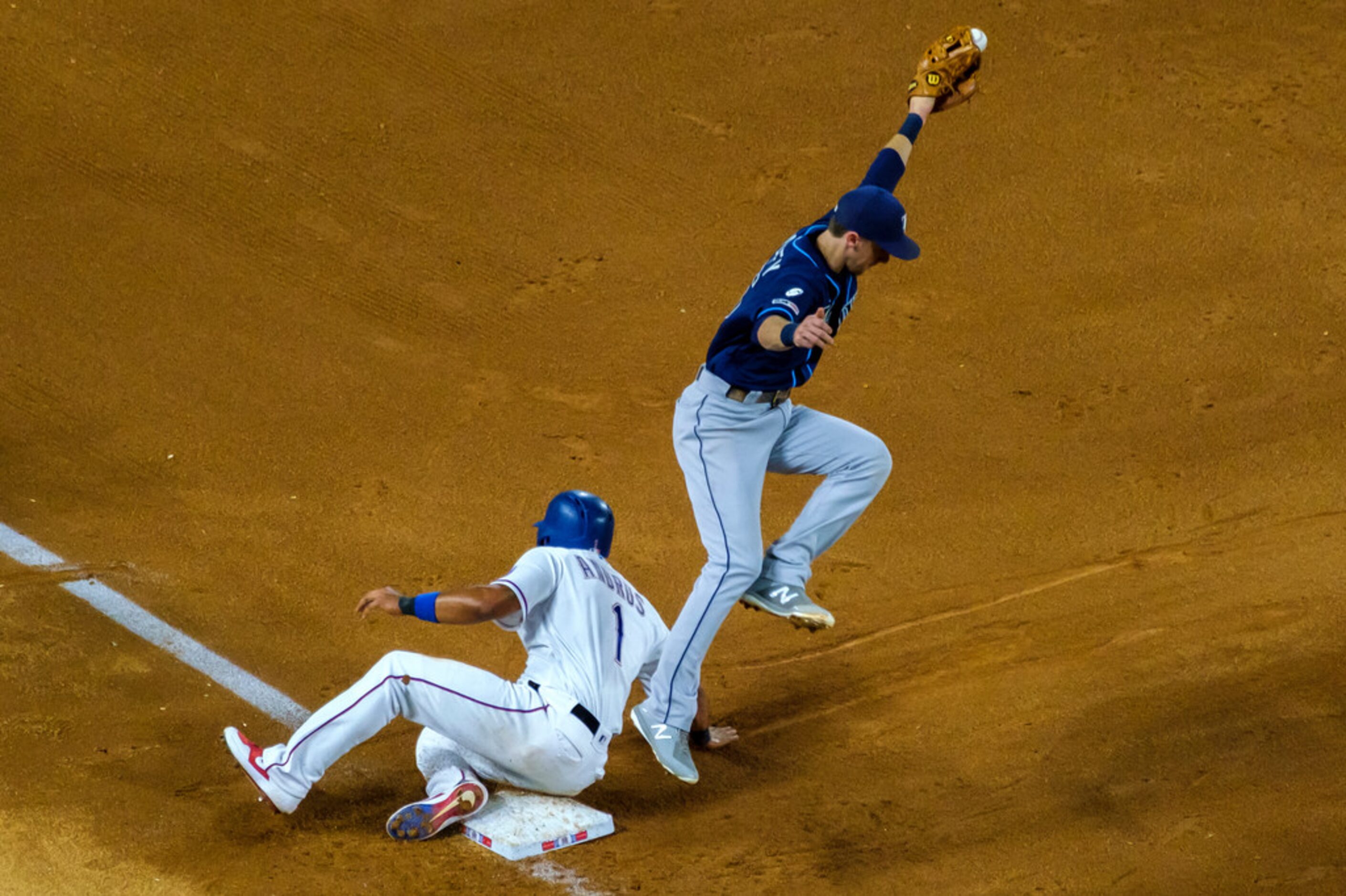 Texas Rangers shortstop Elvis Andrus (1) steals third base as Tampa Bay Rays third baseman...