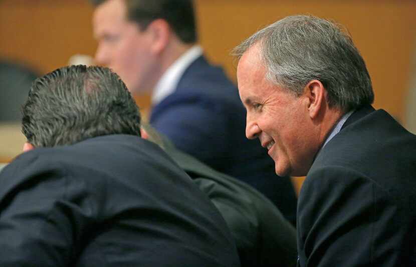 Texas Attorney General Ken Paxton, right, smiles during his pretrial hearing ahead of his...