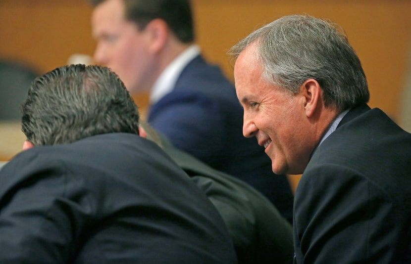 Texas Attorney General Ken Paxton, right, smiles during his pretrial hearing ahead of his...