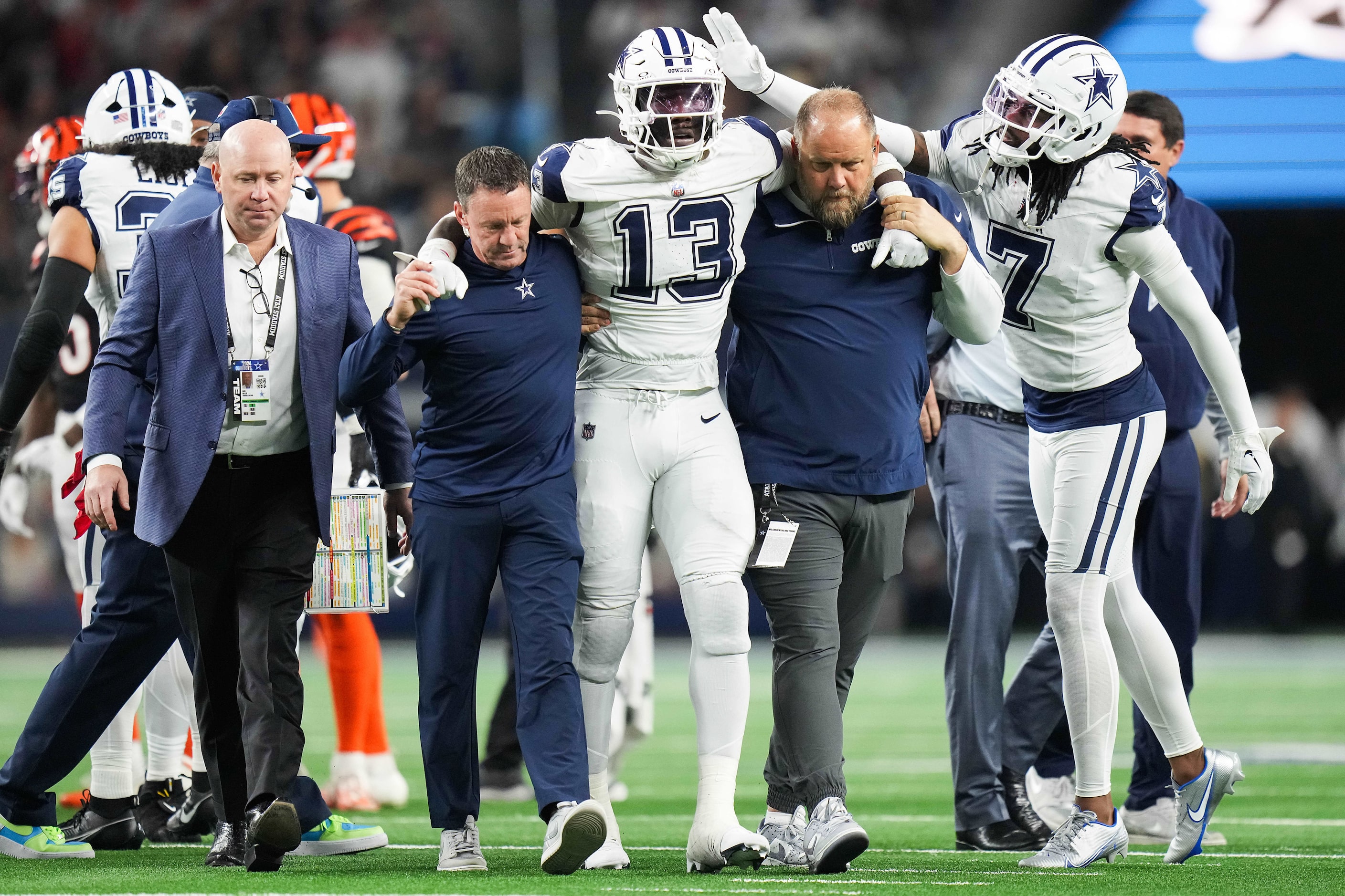 Dallas Cowboys linebacker DeMarvion Overshown (13) is helped off the field after being...