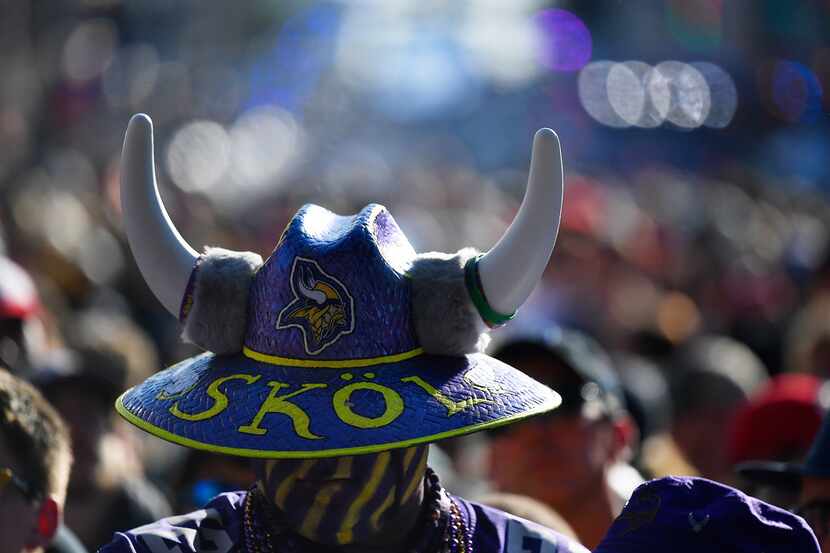 A Minnesota Vikings fan stands near the main stage ahead of the second round of the NFL...