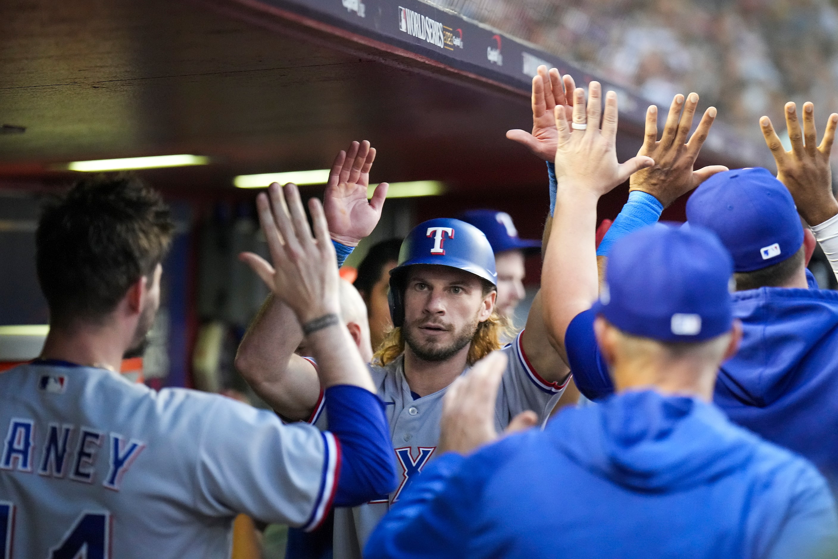 Texas Rangers right fielder Travis Jankowski celebrates with pitcher Andrew Heaney and...