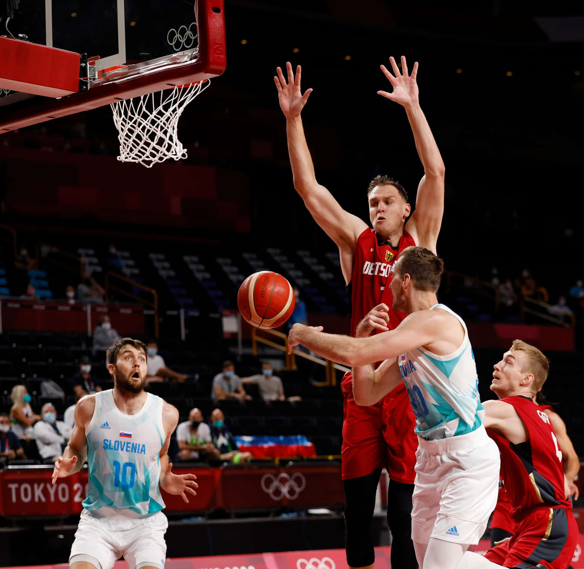 Slovenia’s Zoran Dragic (3) passes the ball to Mike Tobey (10) as Germany’s Johannes...