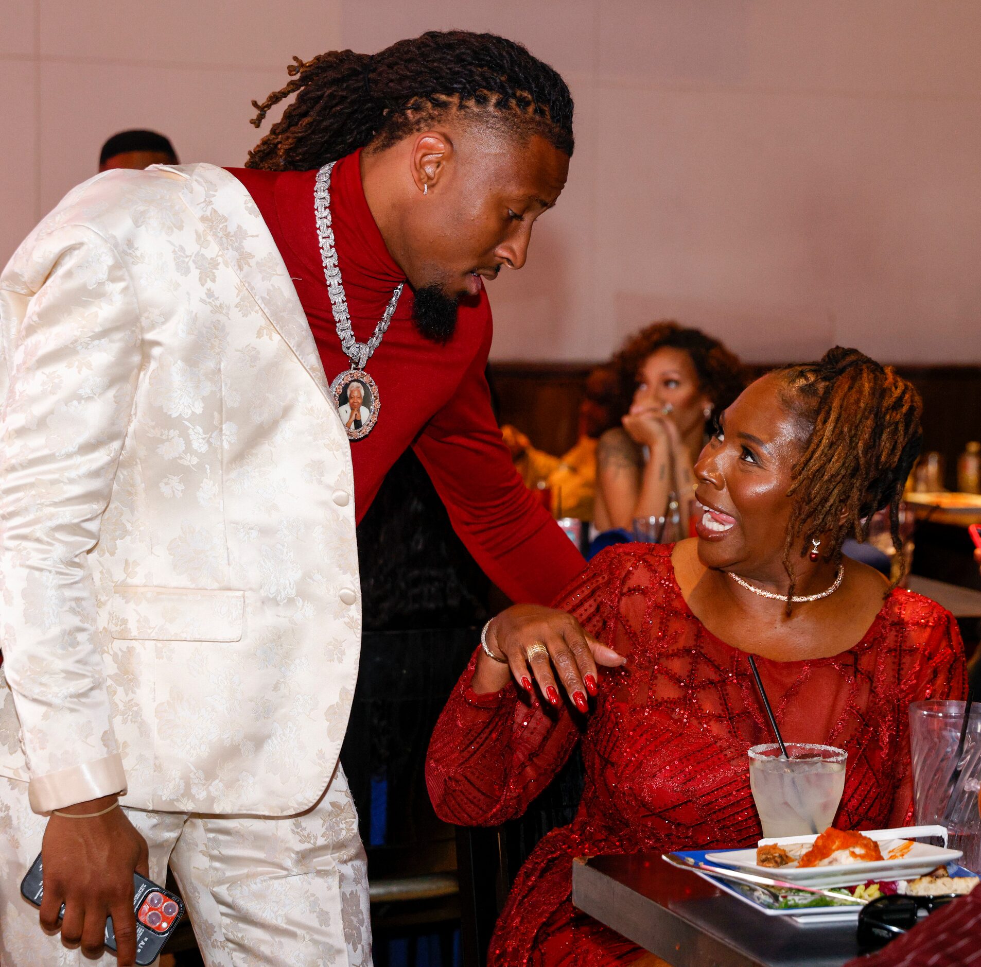 TCU wide receiver Quentin Johnston talks with his mother Sherry Johnston during a 2023 NFL...