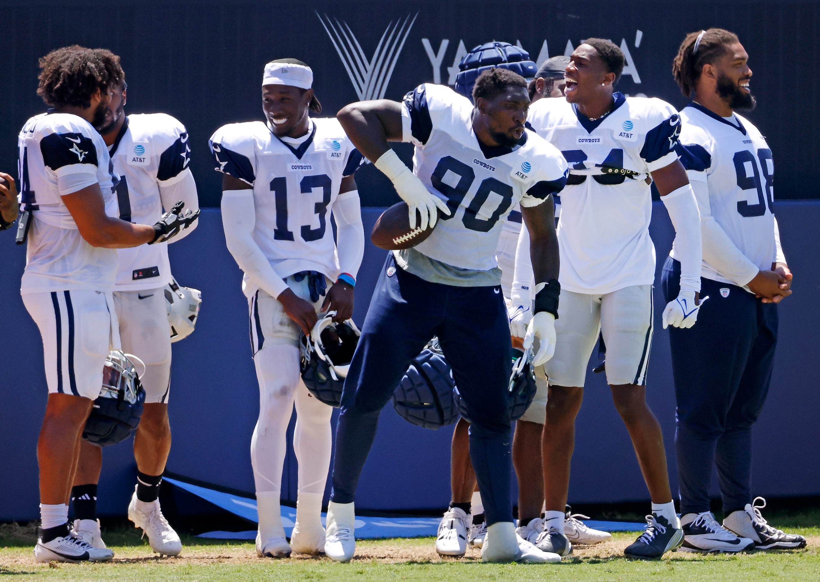 Dallas Cowboys defensive end DeMarcus Lawrence (90) spikes the ball after catching a pass on...