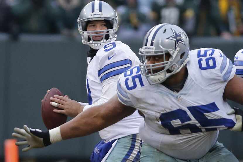 Dallas Cowboys quarterback Tony Romo (9) gets set to throw the controversial fourth-down...