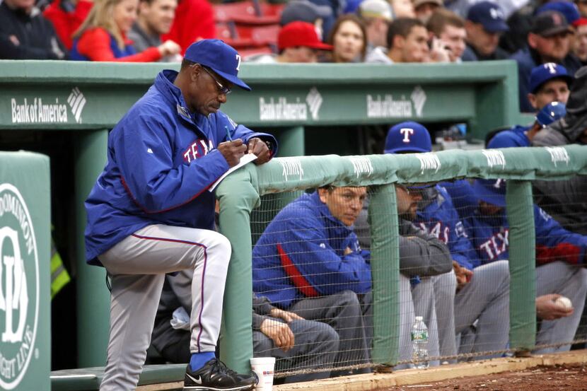 Texas Rangers manager Ron Washington check his notes in the first inning of a baseball game...