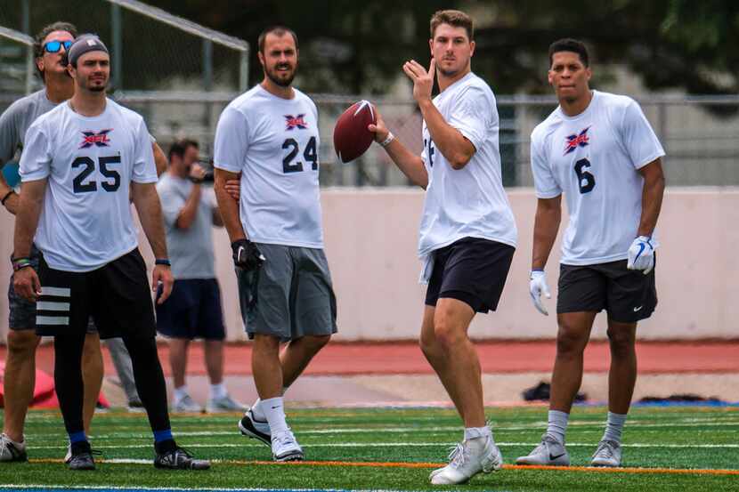 Quarterback Foster Sawyer throws a pass as Peter Pujals (25), Landry Jones (24) and Jalen...