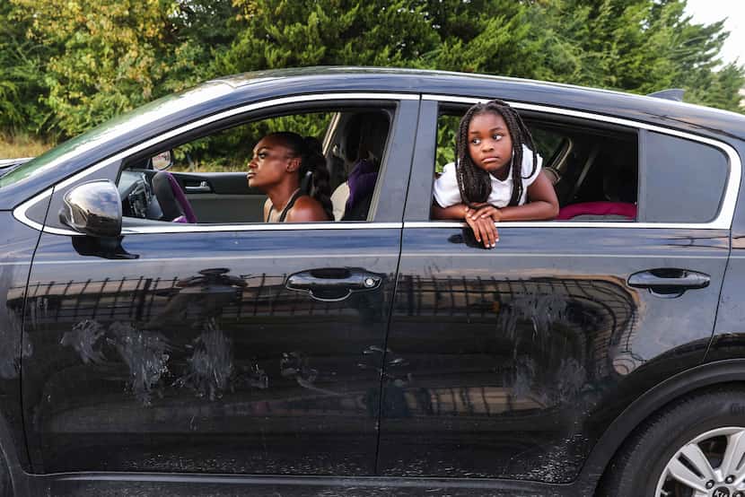 Highland Hills Apartments resident Dejanette Dennis and one of her daughters, 7-year-old...
