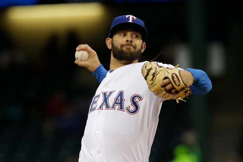 Texas Rangers starting pitcher Nick Martinez throws during the first inning of a baseball...