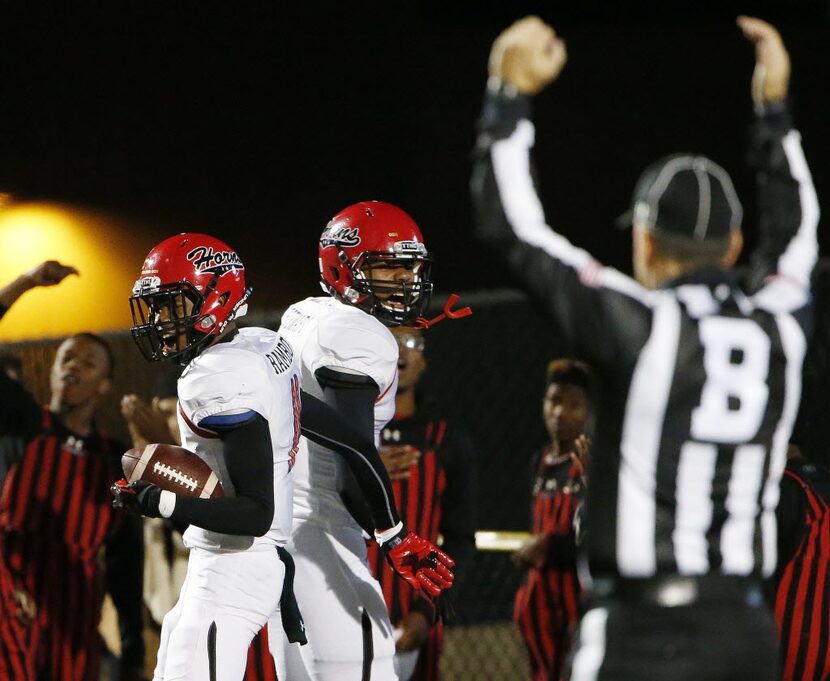 Cedar Hill wide receiver Charleston Rambo (11), left,  celebrates a touchdown reception with...