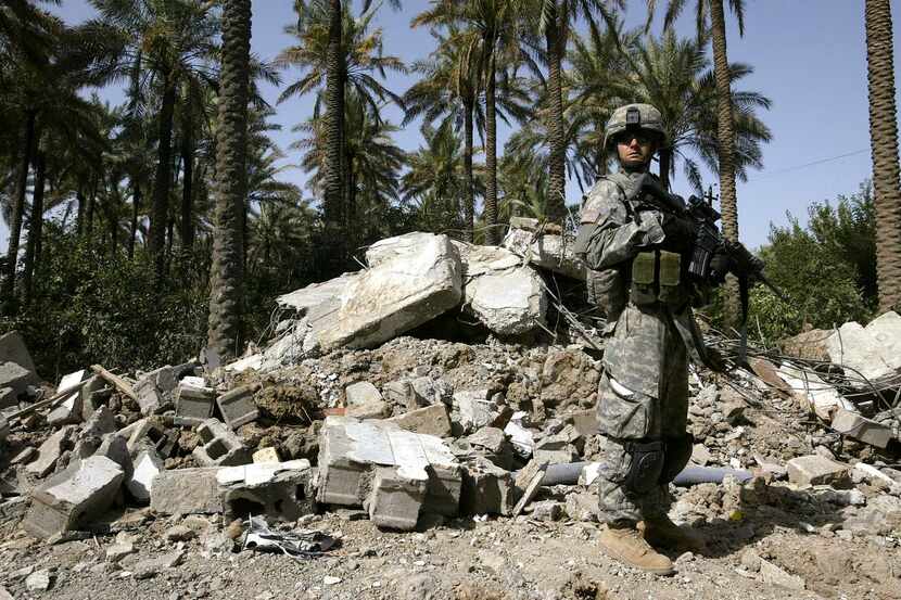A U.S. soldier  stood near rubble after the June 10, 2006, airstrike that killed Abu Musab...