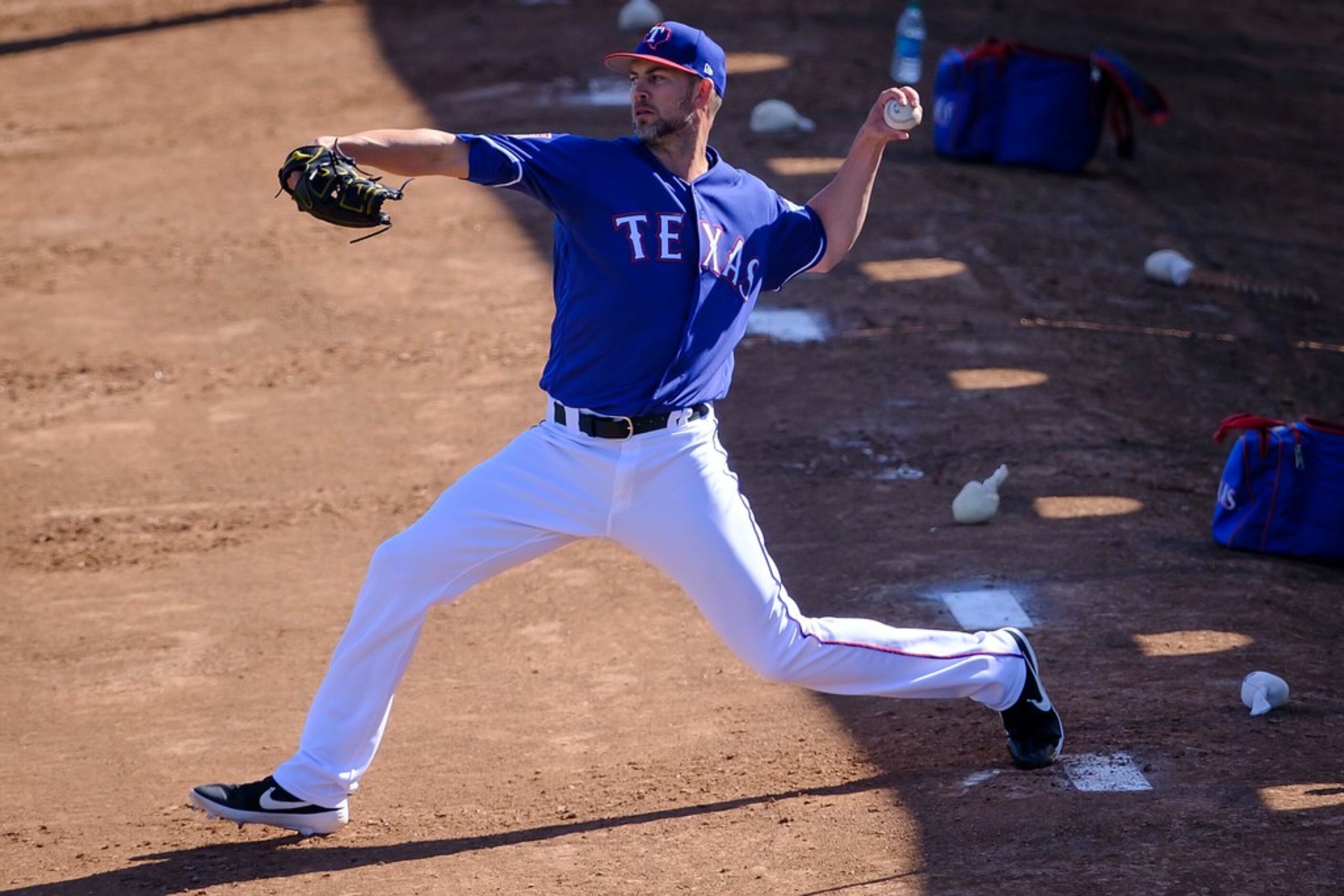 Texas Rangers pitcher Mike Minor throws in the bullpen during a spring training workout at...