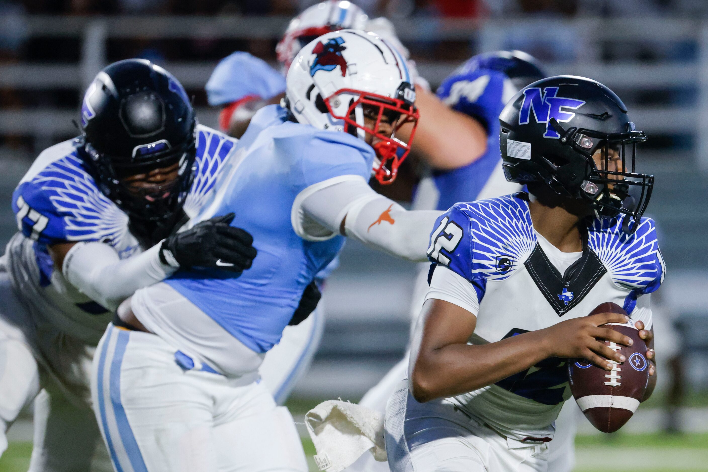 North Forney High’s QB Michael Douglas (12) looks to throw the ball during the first half of...