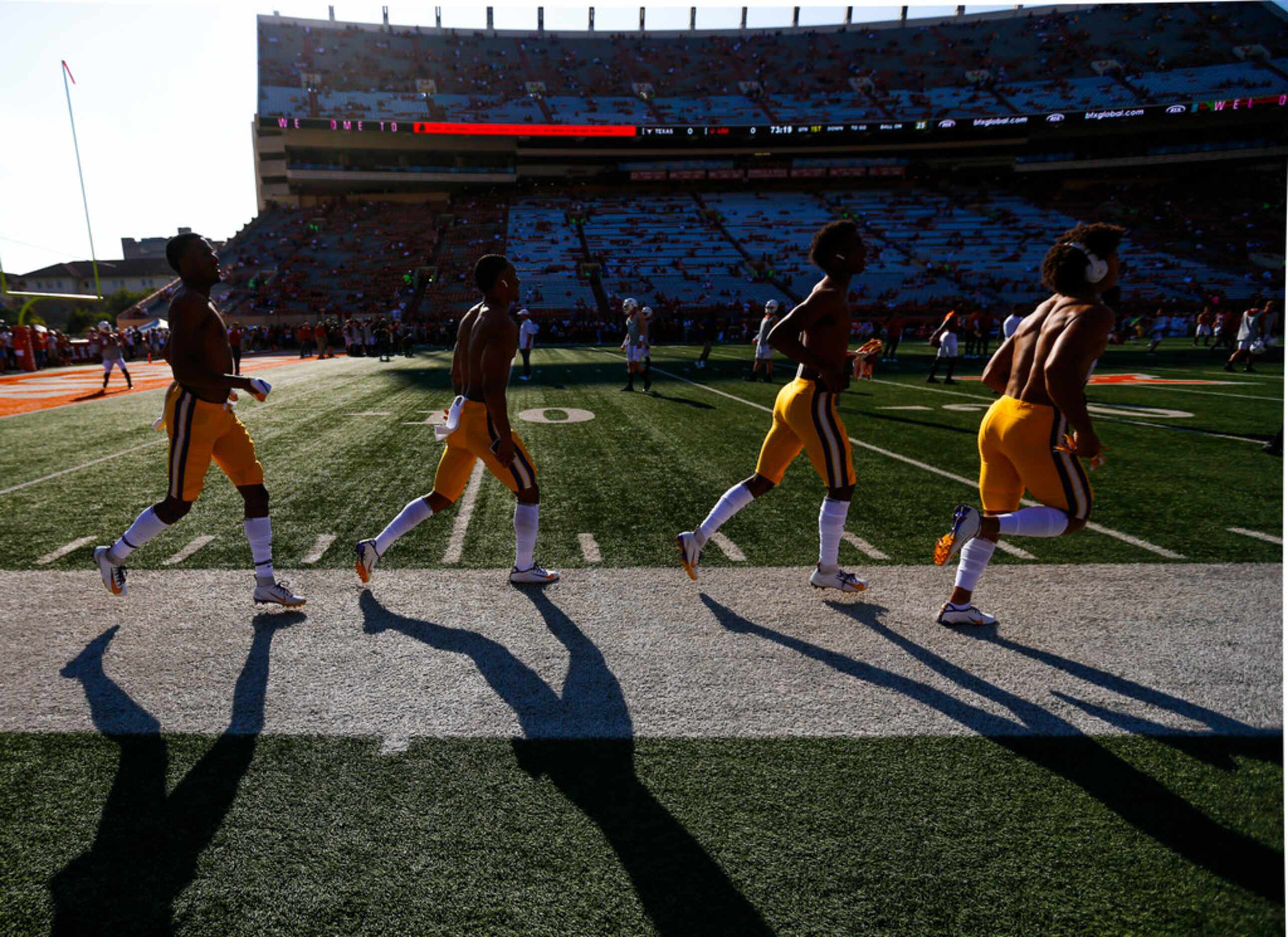 LSU Tigers players break onto the field for warm ups prior to a college football game...