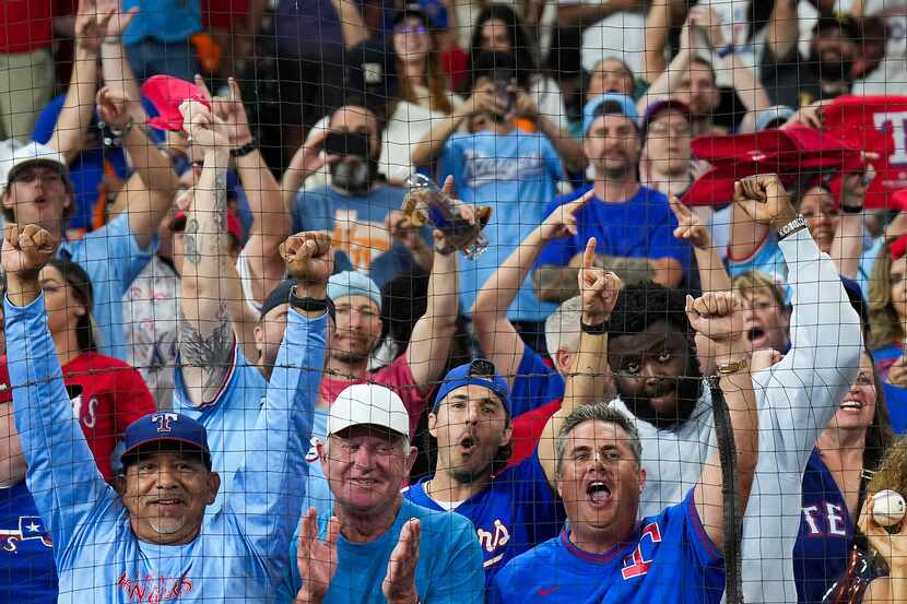 Texas Rangers fans celebrate after a victory over the Houston Astros in Game 7 of the...