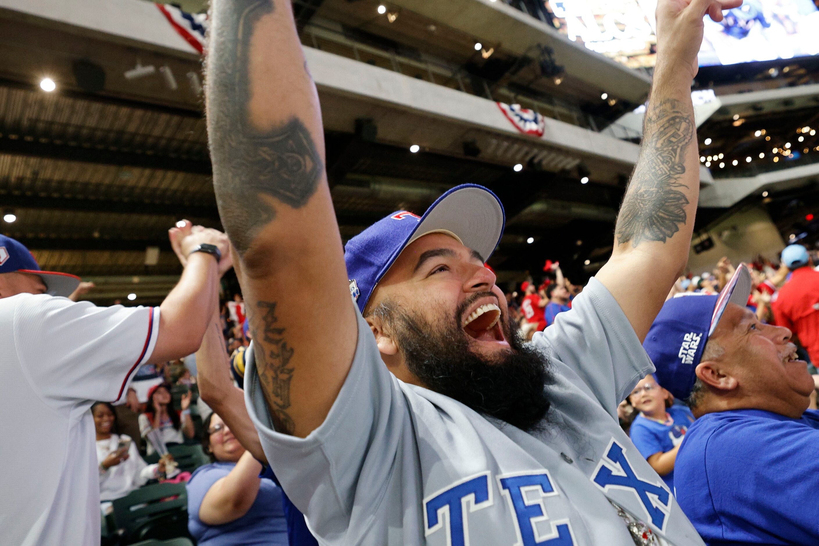 Texas Rangers fan John Sanchez of Cedar Hill reacts during a Game 7 watch party of the...