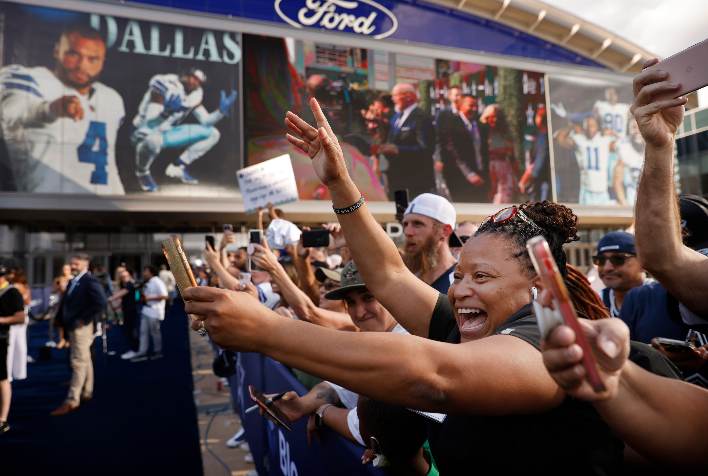 Dallas Cowboys fans cheer and shoot photos of Dallas Cowboys quarterback Dak Prescott as he...