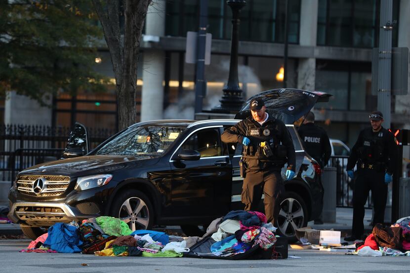 Members of the U.S. Secret Service examine belongings removed from a Mercedes-Benz that was...