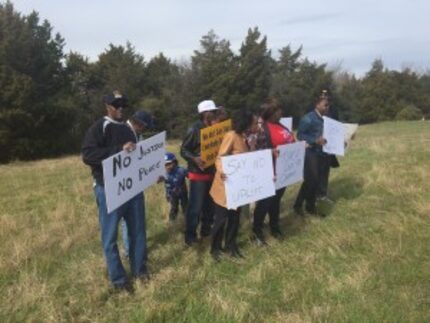  Opponents of a proposed Uplift charter school show their opposition at the proposed site in...