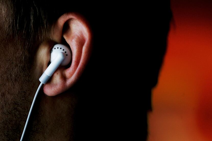 A man listens to an iPod MP3 player through earphones August 17, 2005 in Sydney, Australia....